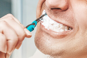 Close of up a man brushing his teeth